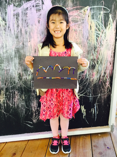 Carmel Mountain Preschool After School Program student with finished art project