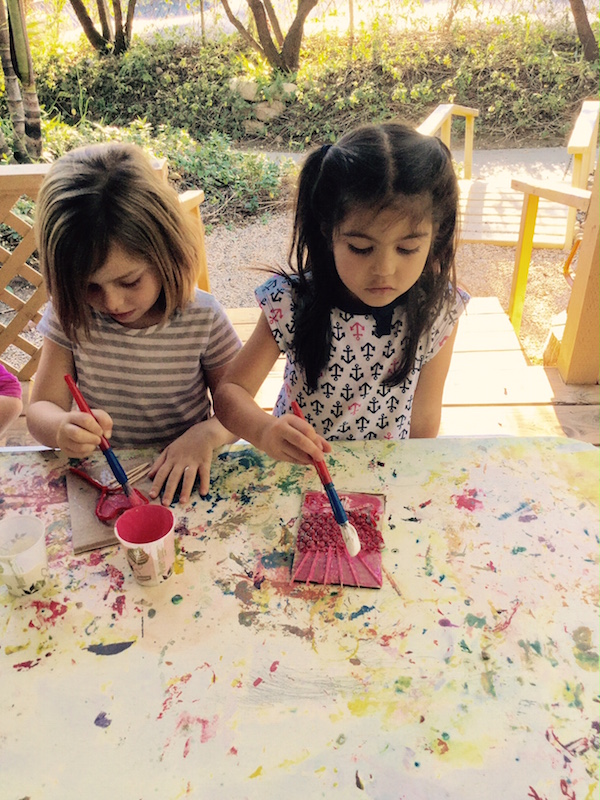 Girls painting in preschool art class