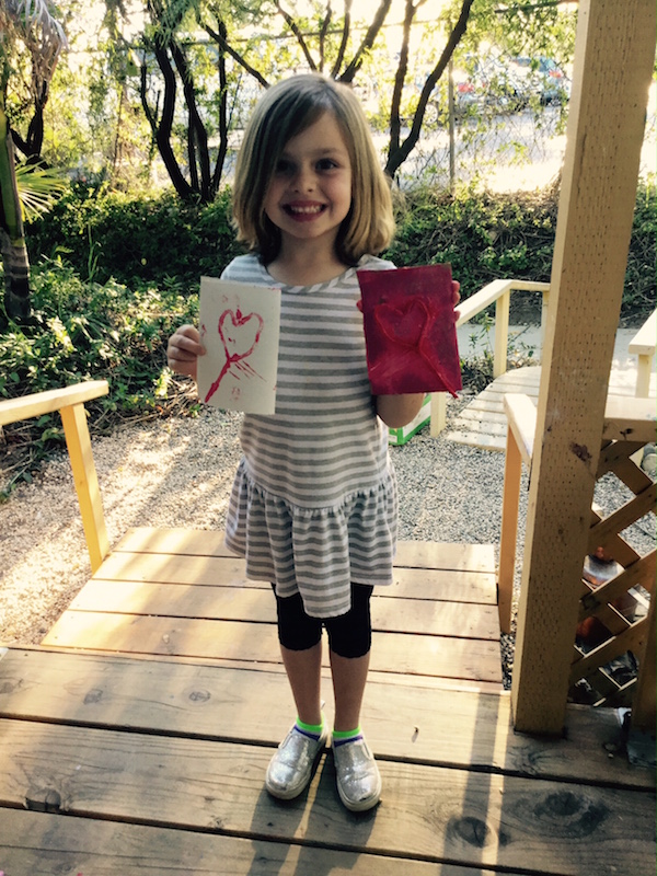Carmel Mountain Preschool student with Valentines Day art project