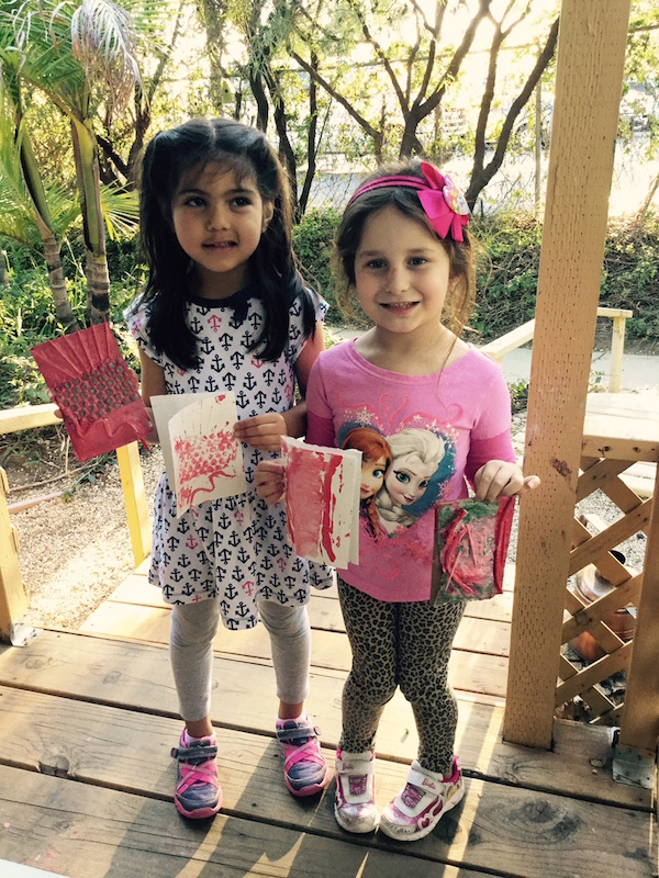 Carmel Mountain Preschool students with finished Valentine's Day art class project