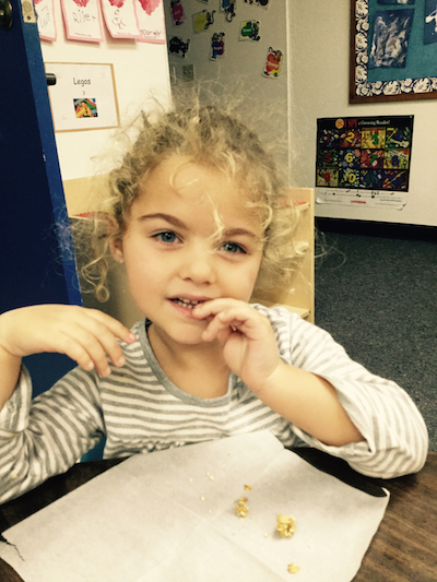 Carmel Mtn. Preschool student enjoying a healthy granola bar snack