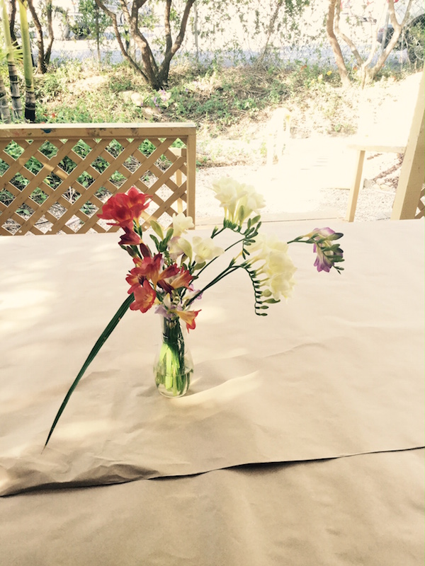 Spring flowers in vase on table outside