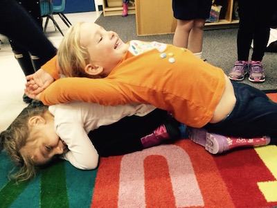 Kids doing partner yoga at school