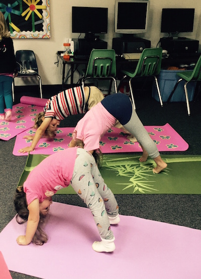 Preschool kids doing Downward Facing Dog yoga pose