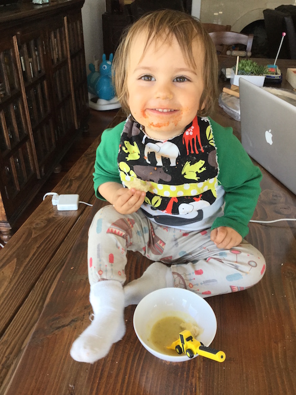 Cute toddler boy enjoying mom's potato leek soup