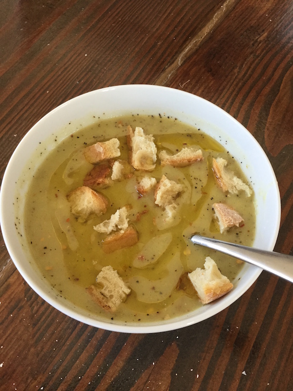 Potato Leek Soup in bowl with organic bread cubes on top