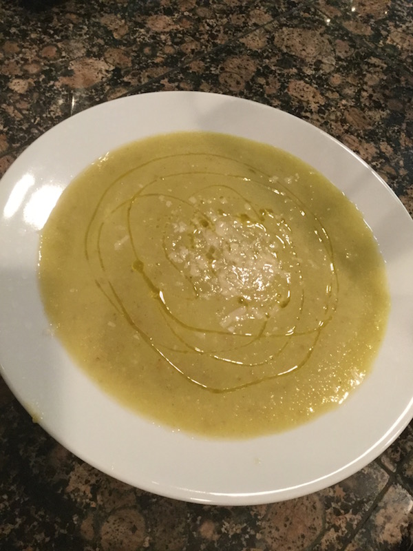 Potato Leek Soup in white bowl with olive oil drizzled over top
