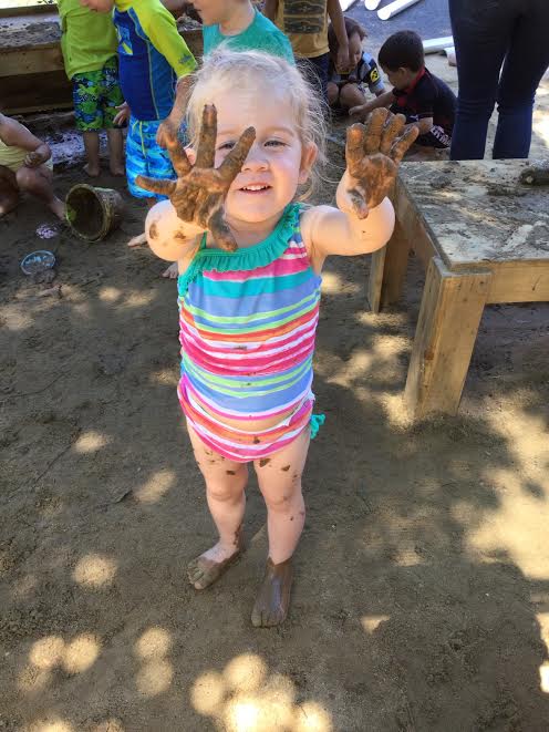 little girl with messy hands