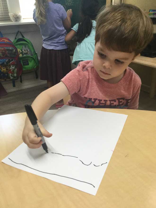 Kid uses marker to draw lines