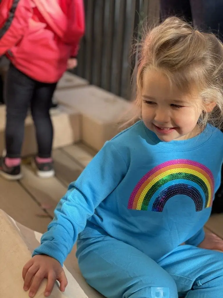 toddler in blue sweatshirt