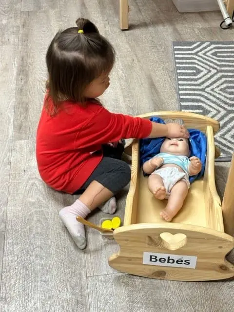 learning how to care for a baby in spanish at preschool