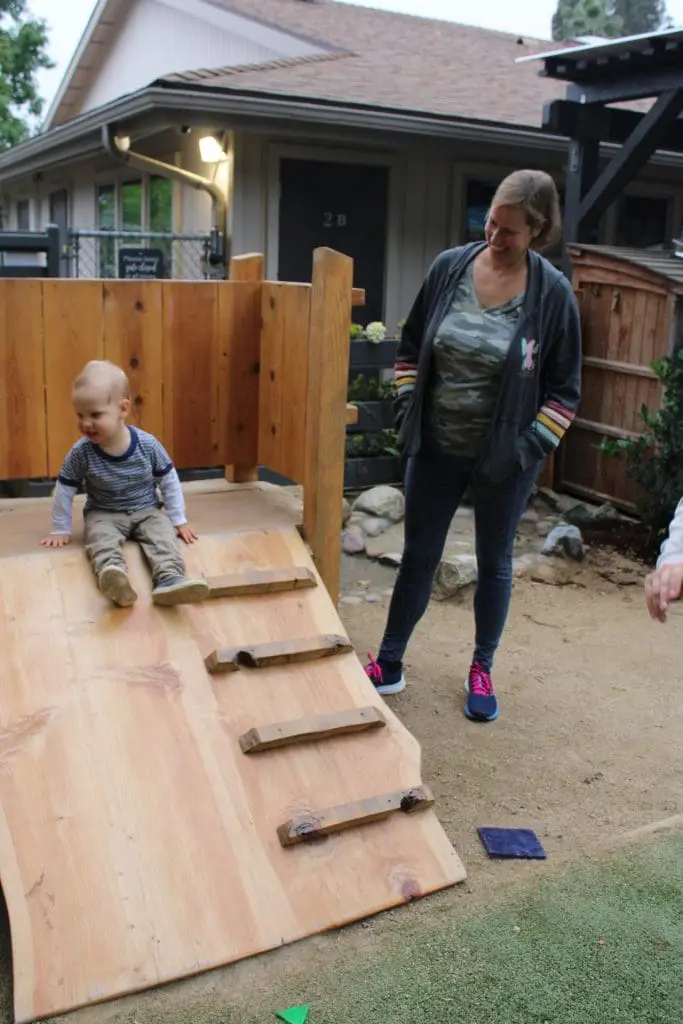 child on playground with parent