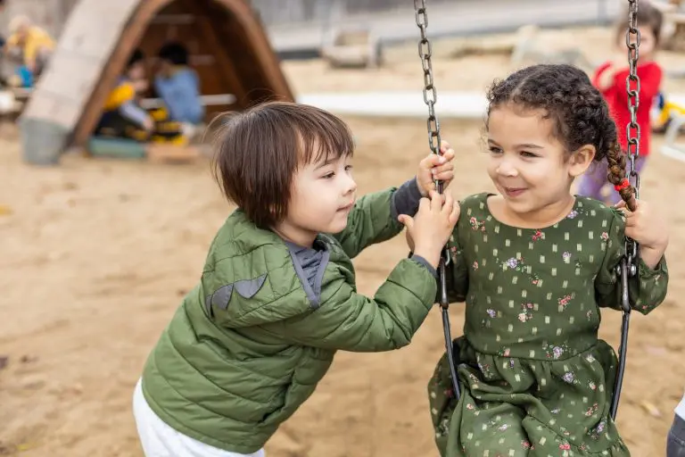 two children on swings at daycare