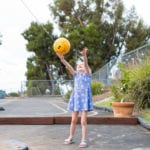 young girl playing tetherball
