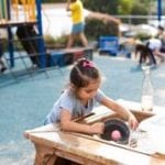 Girl playing with water at preschool