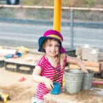 little girl playing with buckets