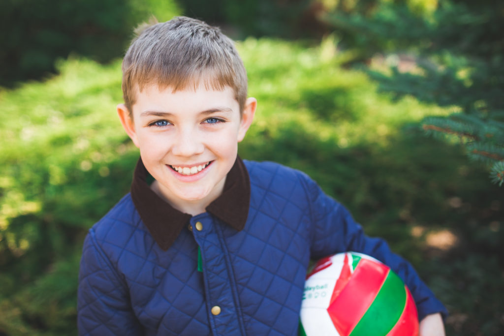Young boy holding soccer ball