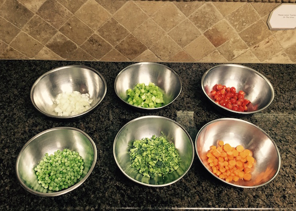 Veggies portioned out in bowls on kitchen counter