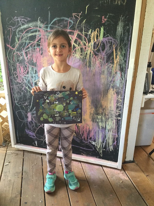 Young girl with painting from art class