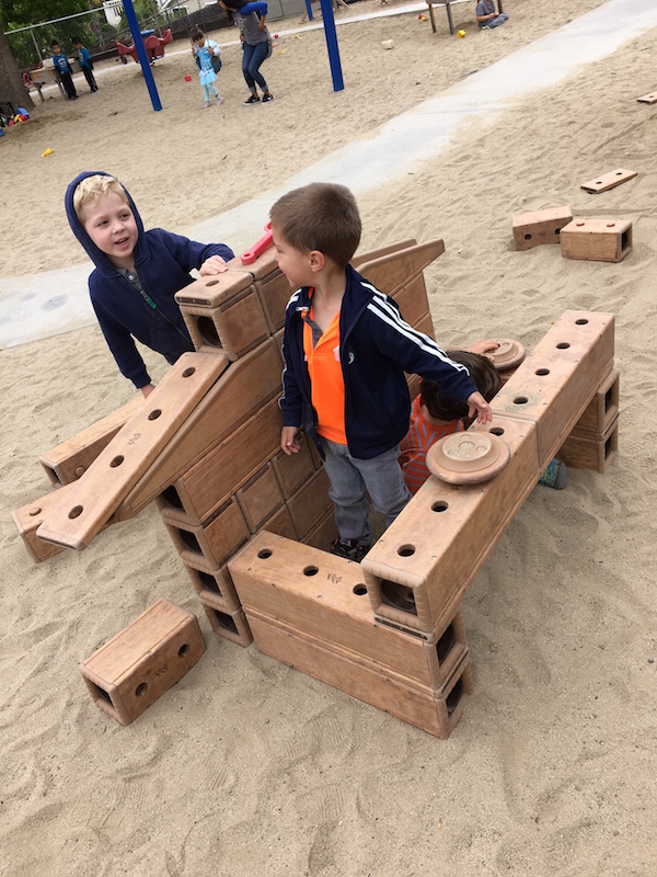Carmel Mountain Preschool boys having fun with large outdoor wood block playset