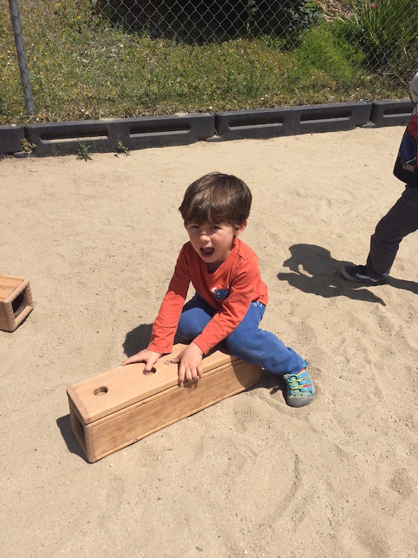 CMP student having fun with outdoor woodblock playset on playground