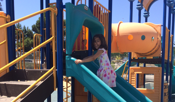girl climbing up slide 