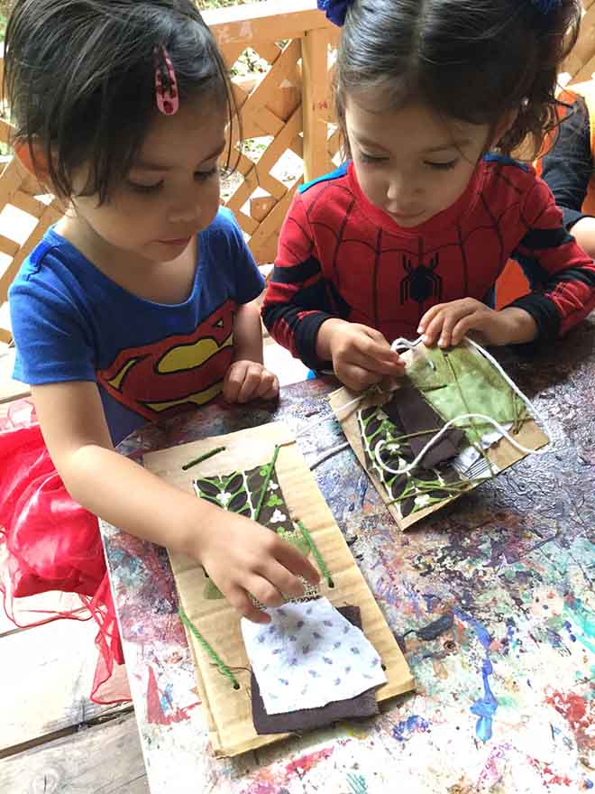 Toddlers working together on an art project