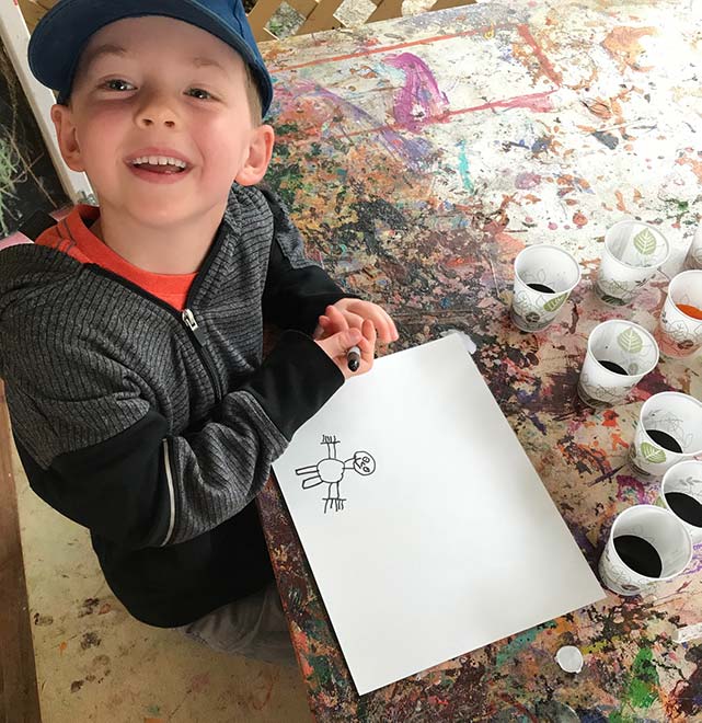 boy starts a drawing of spring