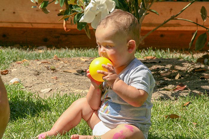 Child biting on a ball