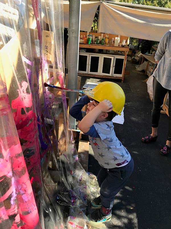 Child painting with a helmet at our preschool