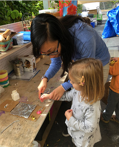 teacher working with a child at our childcare center on an art project