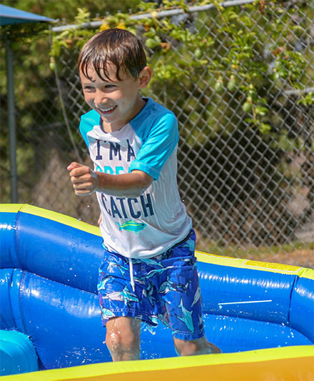 boy in pool at child care center