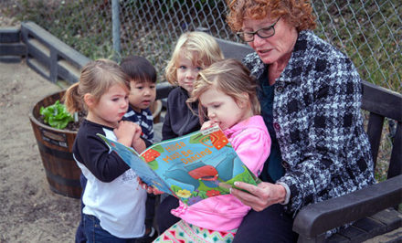 grandma reading to children at child care center