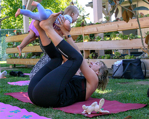 mom and kid doing yoga in summer