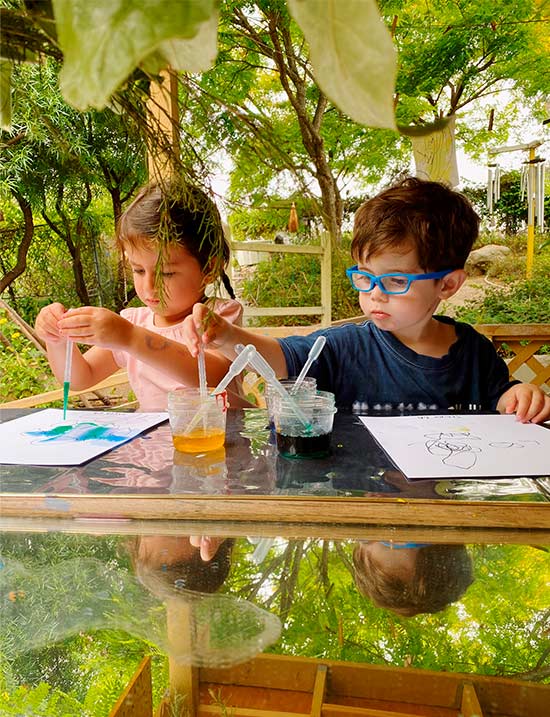 boy and girl painting with water colors