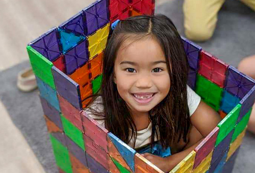 kindergarten girl in colorful box