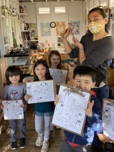 ms selena with kids drawings at preschool