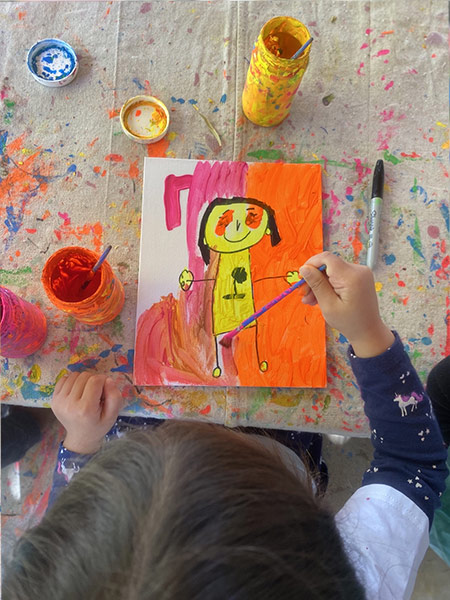 girl painting a girl at preschool