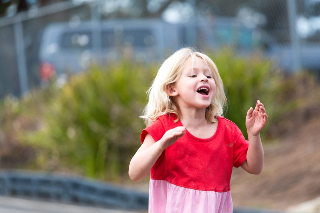 girl running outdoors at preschool