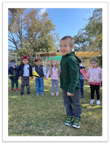 boy with paper airplane at preschool