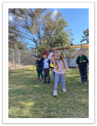 kids throwing paper airplane at preschool