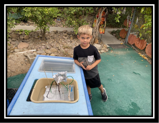 boy with completed boat at preschool