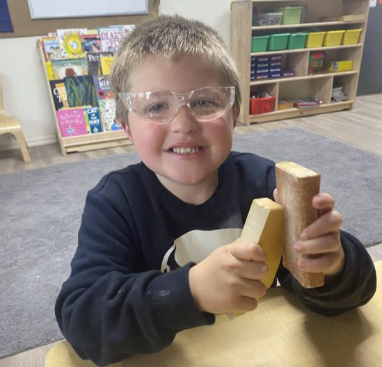 boy with wood blocks at preschool]