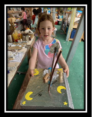 girl with completed boat at preschool