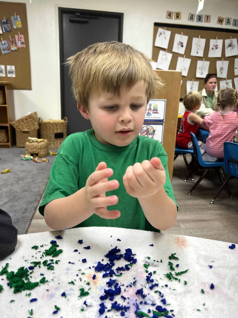 boy working on earth day crafts