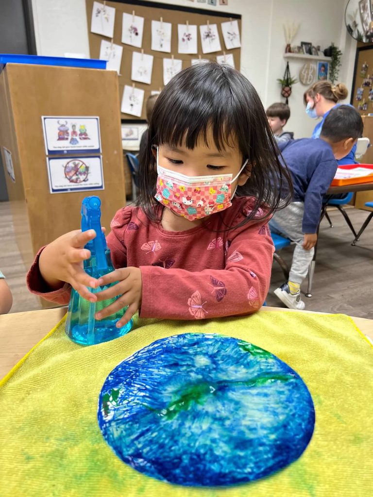 girl crafting on earth day at preschool