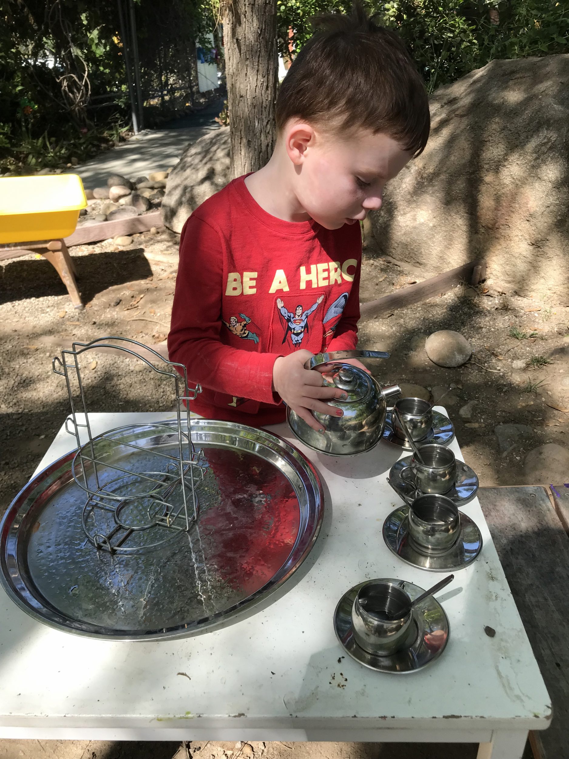 boy at pouring station at preschool