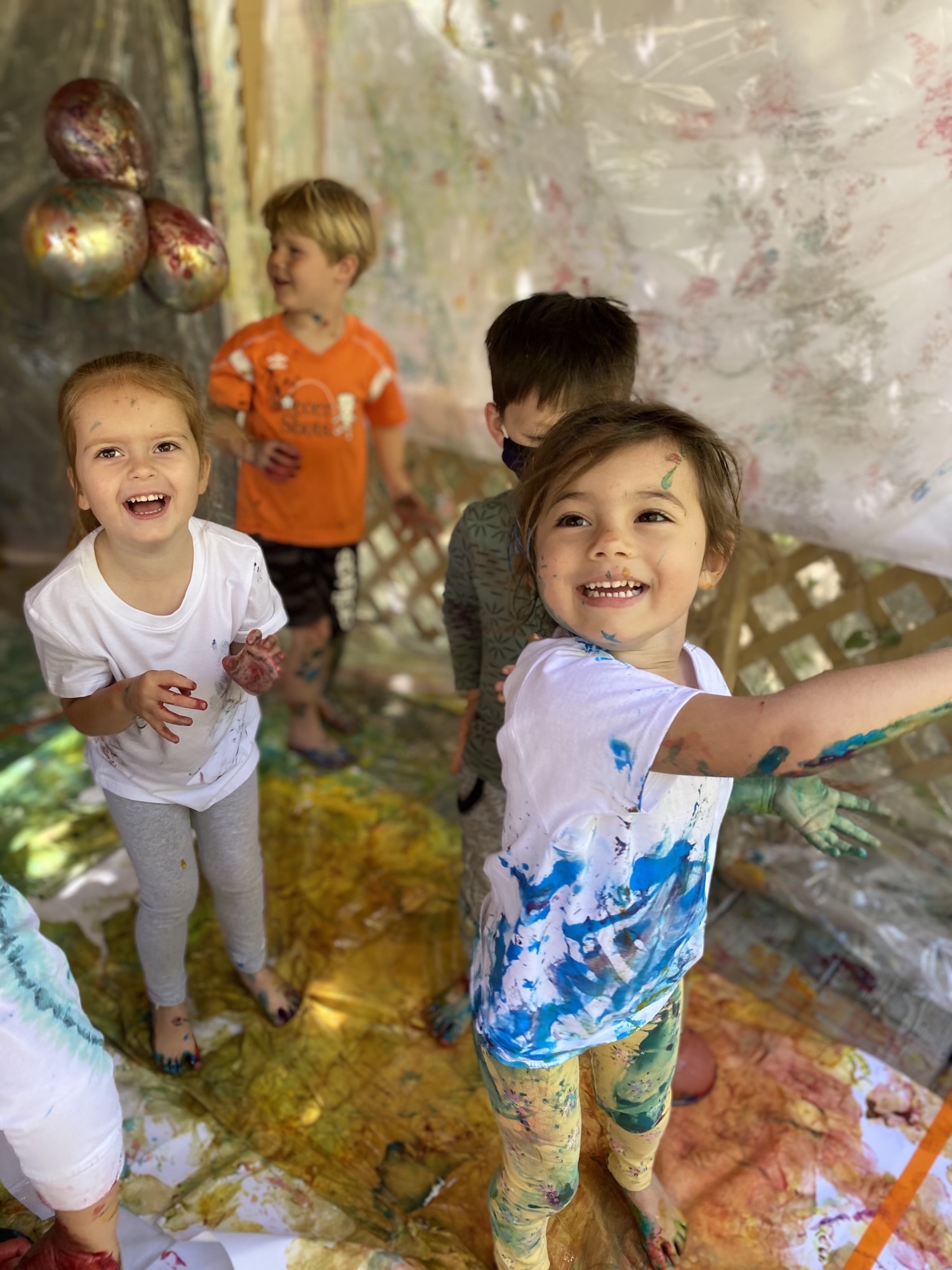 young kids with paint balloons at preschool