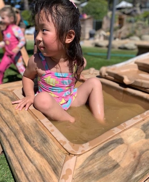 girl in mud bath at preschool