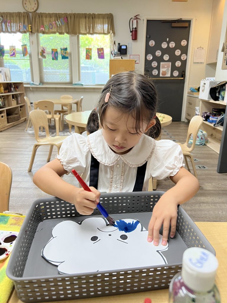 girl coloring artwork at preschool